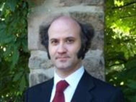 A person in a suit and tie
AI-generated content may be incorrect.